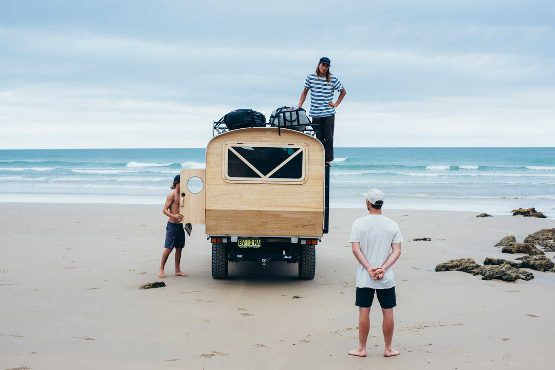 Camper on the beach checking the waves