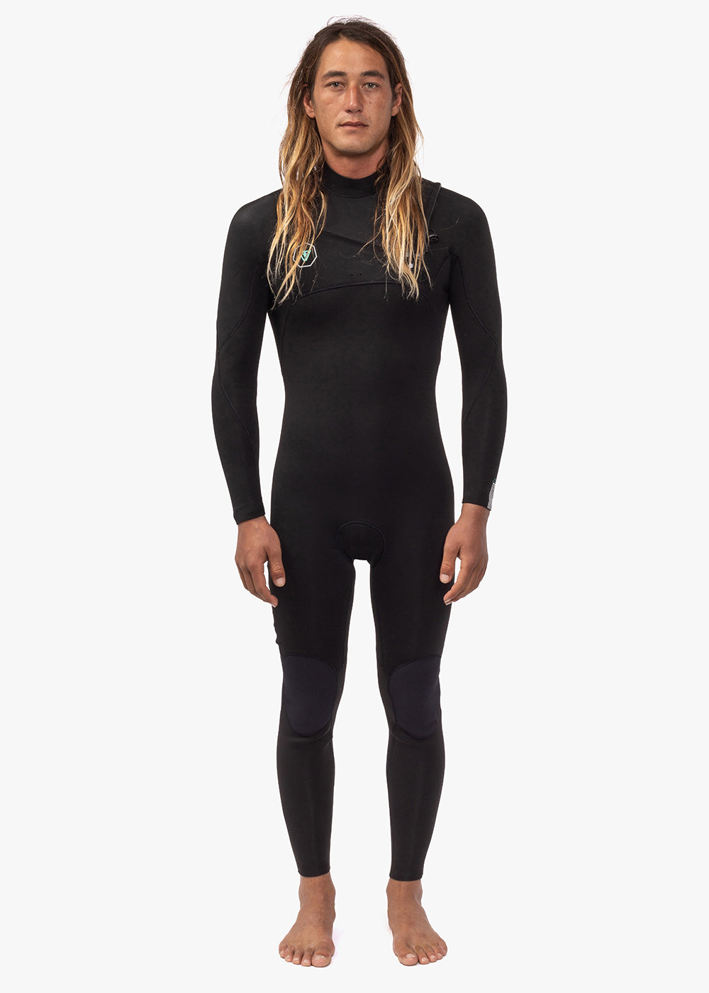 A person wearing a full-body black chest zip wetsuit, standing against a white background.